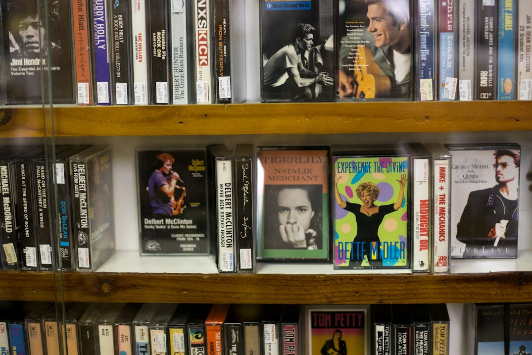 Swiss man archivist standing among shelves of videotapes