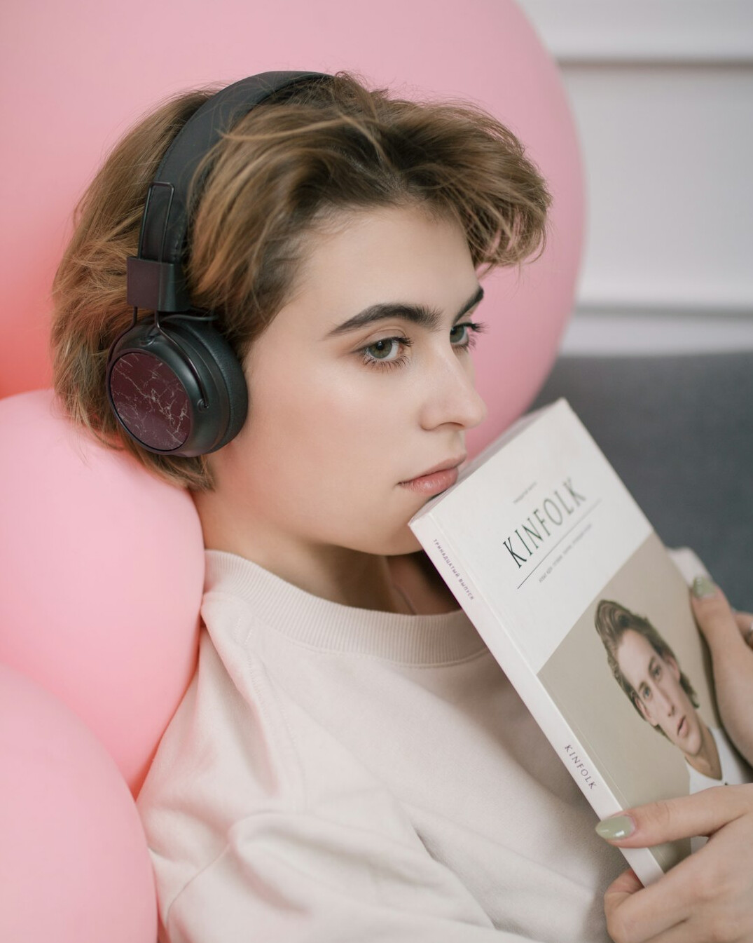 Swiss woman journalist writing at a laptop with headphones