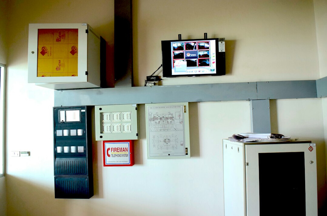 Television control room with rows of monitors and a mixing console